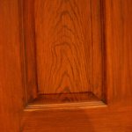 Wood grain was hand painted into the door to emphasize the stamped texture.  Wood frame was pigment and wax rub.